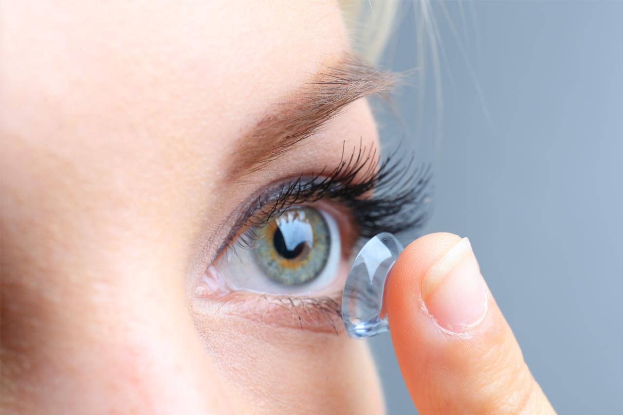 Woman putting in contact